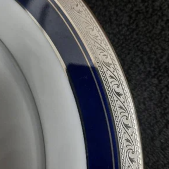 a white porcelain plate with a cobalt blue rim